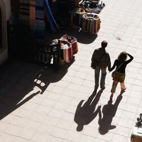 13786620-A-Couple-Walking-In-The-Streets-Of-Essaouira-Morocco